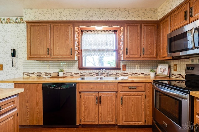 6139 N State Route 48, Clearcreek Twp, OH 45036 - kitchen with stainless steel appliances, a sink, light countertops, and wallpapered walls