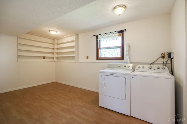 6139 N State Route 48, Clearcreek Twp, OH 45036 - laundry room featuring separate washer and dryer, a textured ceiling, light wood finished floors, and baseboards