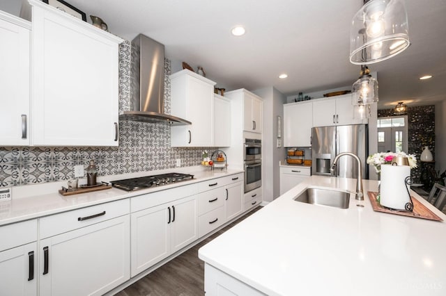 5038 Maiden Way, Liberty Twp, OH 45011 - kitchen featuring appliances with stainless steel finishes, wall chimney range hood, a sink, white cabinetry, and light countertops