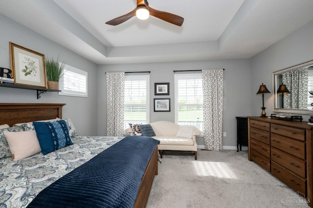 5038 Maiden Way, Liberty Twp, OH 45011 - bedroom featuring multiple windows, a tray ceiling, light carpet, and baseboards