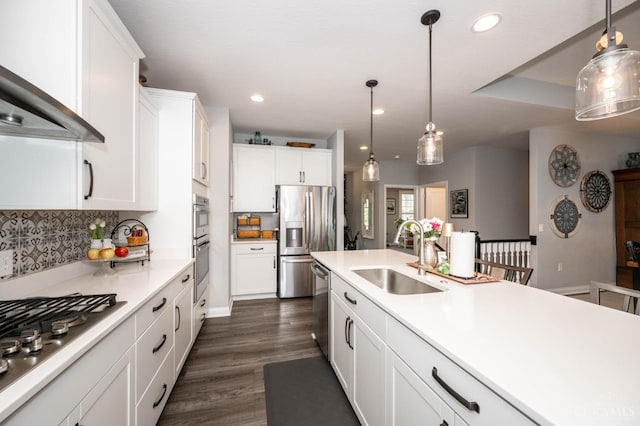 5038 Maiden Way, Liberty Twp, OH 45011 - kitchen featuring a sink, appliances with stainless steel finishes, wall chimney exhaust hood, white cabinets, and pendant lighting