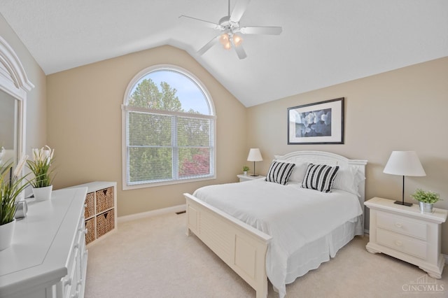 bedroom with baseboards, ceiling fan, light carpet, and lofted ceiling