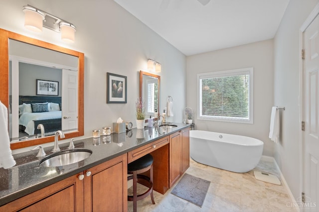 ensuite bathroom with double vanity, a sink, ensuite bath, and a freestanding bath