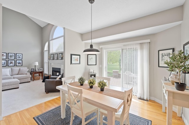 dining space with light wood-type flooring and a fireplace