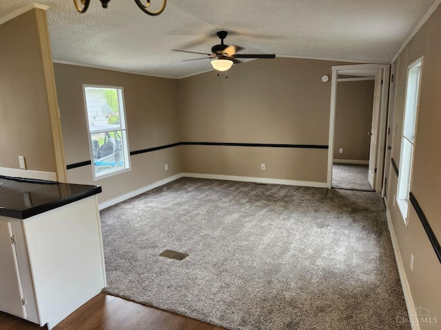 107 Elm St, Georgetown, OH 45121 - unfurnished living room with a ceiling fan, a textured ceiling, dark carpet, and crown molding