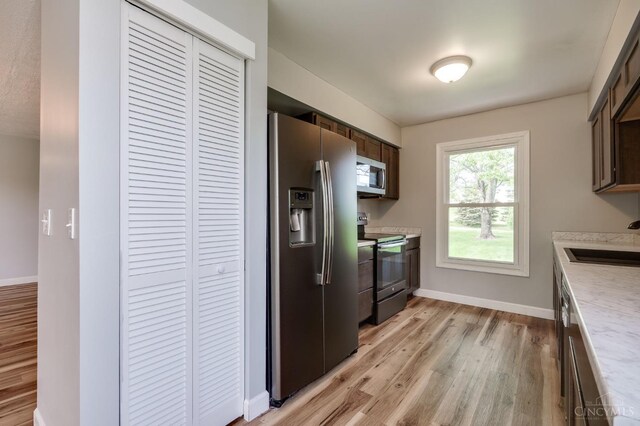 5172 Sheits Rd, Colerain Twp, OH 45251 - kitchen with stainless steel appliances, a sink, light wood-style floors, light countertops, and baseboards