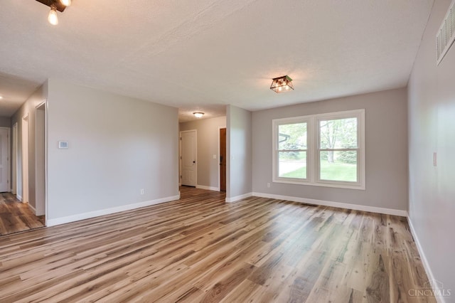 5172 Sheits Rd, Colerain Twp, OH 45251 - empty room with wood finished floors, baseboards, and a textured ceiling
