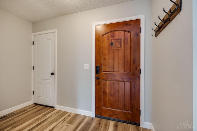 5172 Sheits Rd, Colerain Twp, OH 45251 - foyer with light wood finished floors, baseboards, and a textured ceiling