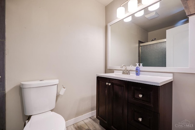 5172 Sheits Rd, Colerain Twp, OH 45251 - full bath featuring wood finished floors, toilet, a shower stall, vanity, and baseboards