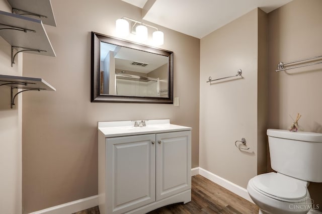5172 Sheits Rd, Colerain Twp, OH 45251 - full bathroom with baseboards, vanity, wood finished floors, toilet, and a shower
