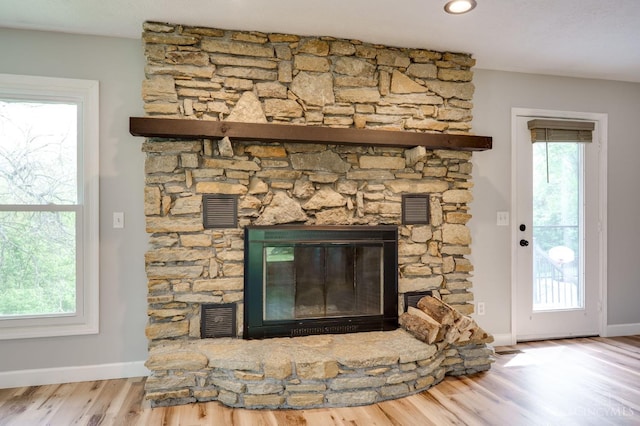 5172 Sheits Rd, Colerain Twp, OH 45251 - detailed view of wood finished floors, a stone fireplace, and baseboards
