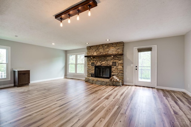 5172 Sheits Rd, Colerain Twp, OH 45251 - unfurnished living room featuring a fireplace, light wood-style floors, baseboards, and a textured ceiling