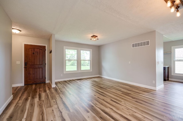 5172 Sheits Rd, Colerain Twp, OH 45251 - foyer entrance with a textured ceiling, wood finished floors, plenty of natural light, and baseboards
