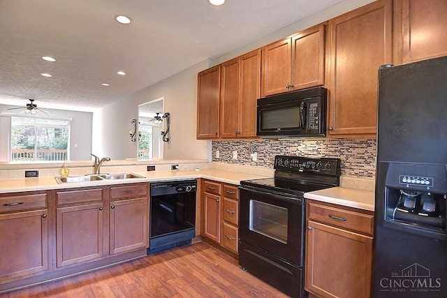 4291 Straight Arrow Rd, Beavercreek, OH 45430 - kitchen featuring black appliances, recessed lighting, light wood-type flooring, light countertops, and backsplash