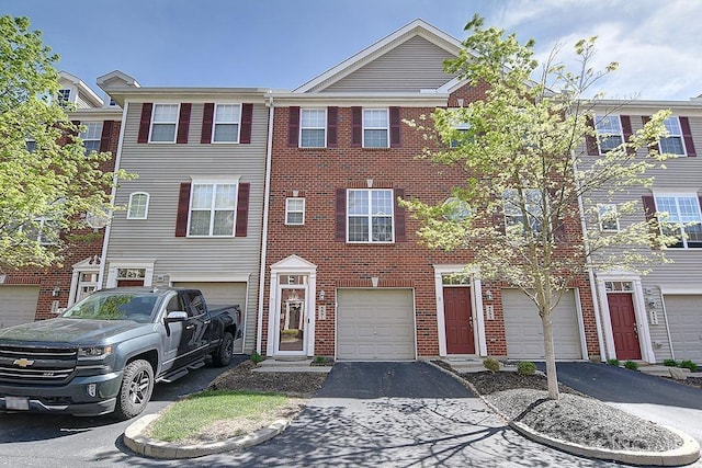 4291 Straight Arrow Rd, Beavercreek, OH 45430 - view of property with driveway, brick siding, and an attached garage