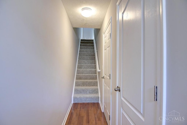 4291 Straight Arrow Rd, Beavercreek, OH 45430 - stairway with wood finished floors and a textured ceiling