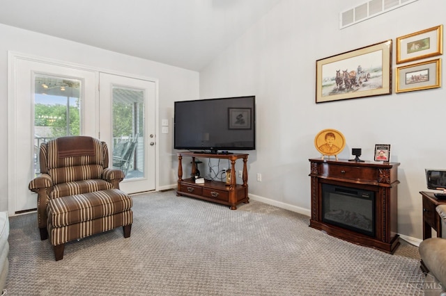 sitting room featuring carpet floors, baseboards, high vaulted ceiling, and visible vents