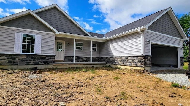 2021 Zuni Dr, Franklin Twp, OH 45171 - view of front of home with stone siding, covered porch, and a garage