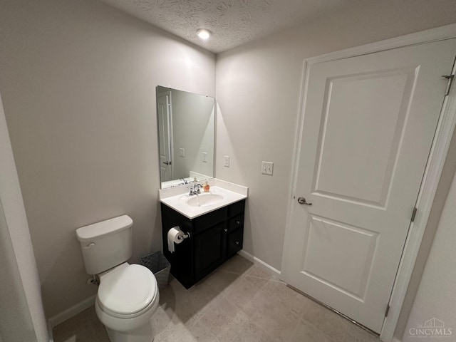 10522 Atterbury Dr, Crosby Twp, OH 45030 - half bathroom with vanity, toilet, a textured ceiling, baseboards, and tile patterned flooring