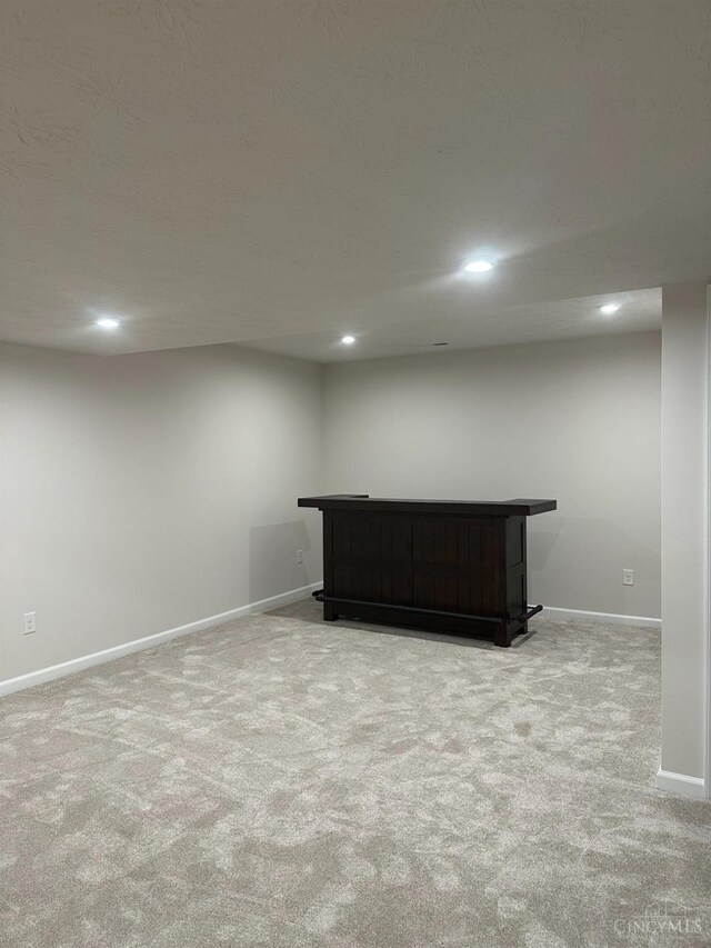 10522 Atterbury Dr, Crosby Twp, OH 45030 - finished basement with light colored carpet, a dry bar, baseboards, and recessed lighting