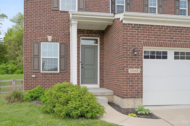 10522 Atterbury Dr, Crosby Twp, OH 45030 - view of exterior entry with brick siding and an attached garage