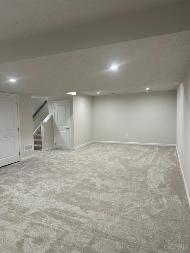 10522 Atterbury Dr, Crosby Twp, OH 45030 - finished basement with baseboards, stairs, carpet, and recessed lighting