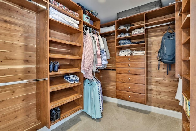 walk in closet with carpet flooring
