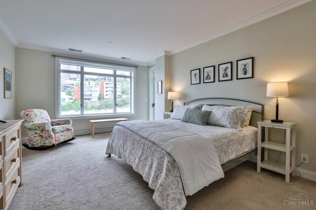 carpeted bedroom featuring ornamental molding