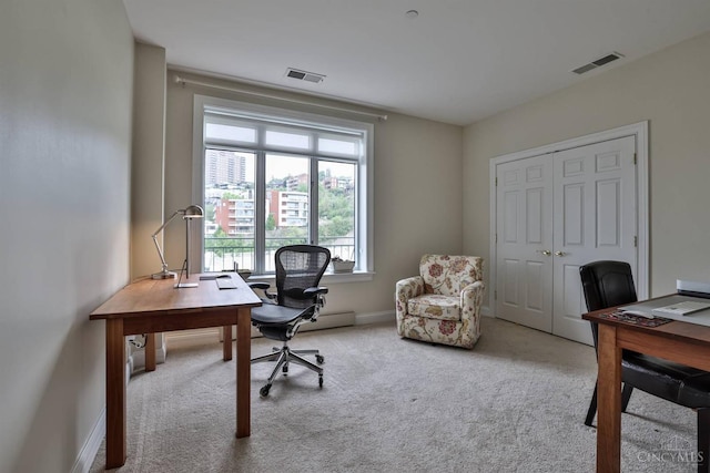 carpeted office space featuring baseboards