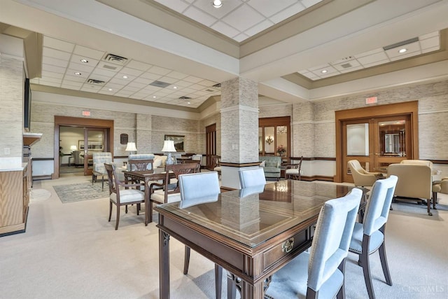 dining space featuring light carpet, decorative columns, and recessed lighting