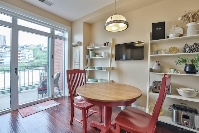 dining space featuring dark wood-style flooring