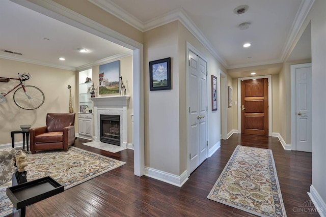 hall featuring wood finished floors, baseboards, crown molding, and recessed lighting