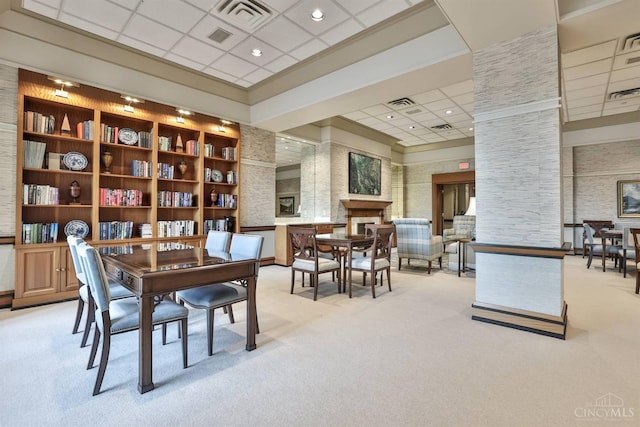 dining area featuring a paneled ceiling, carpet flooring, a fireplace, and recessed lighting