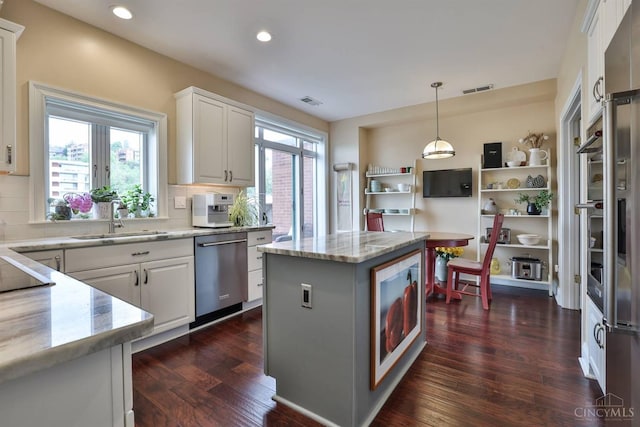 kitchen with dishwasher, a sink, dark wood-type flooring, white cabinetry, and recessed lighting