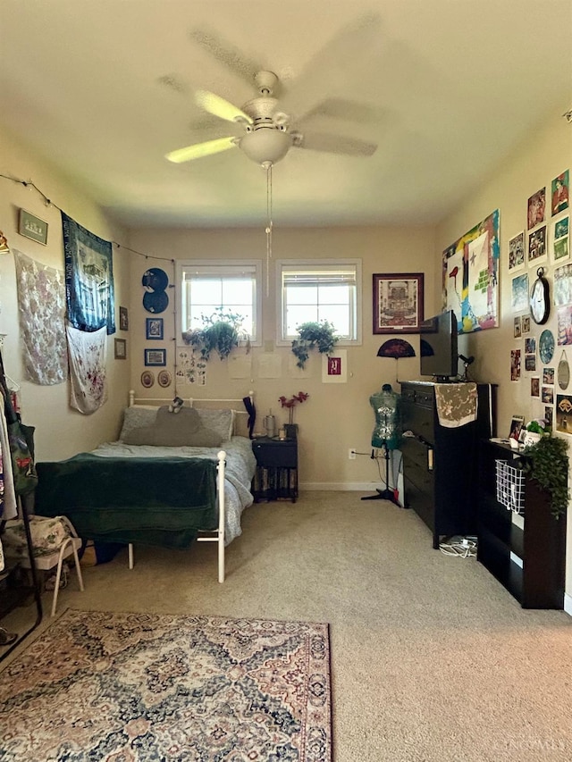 bedroom with ceiling fan, carpet, and baseboards