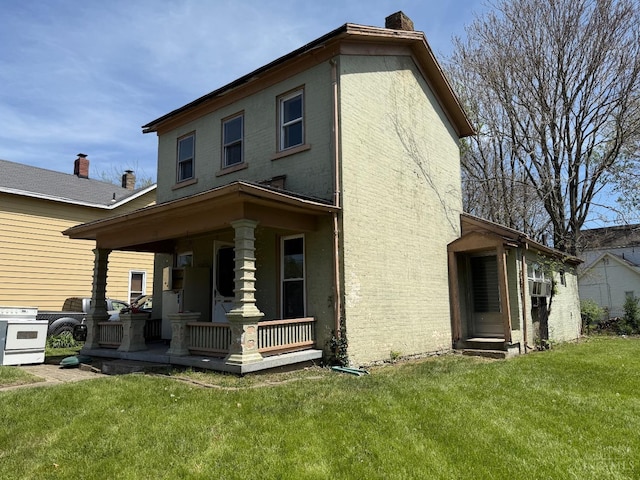 exterior space featuring a porch, a yard, and a chimney