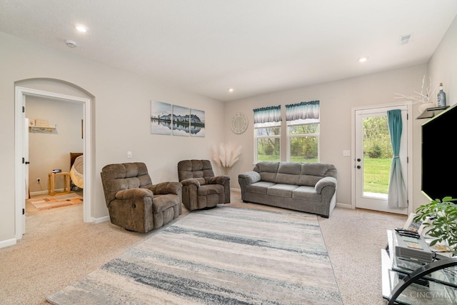 carpeted living room featuring baseboards, visible vents, and recessed lighting