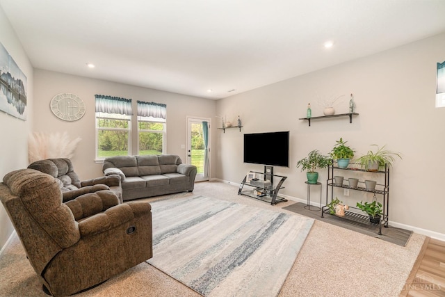 living area featuring baseboards and recessed lighting