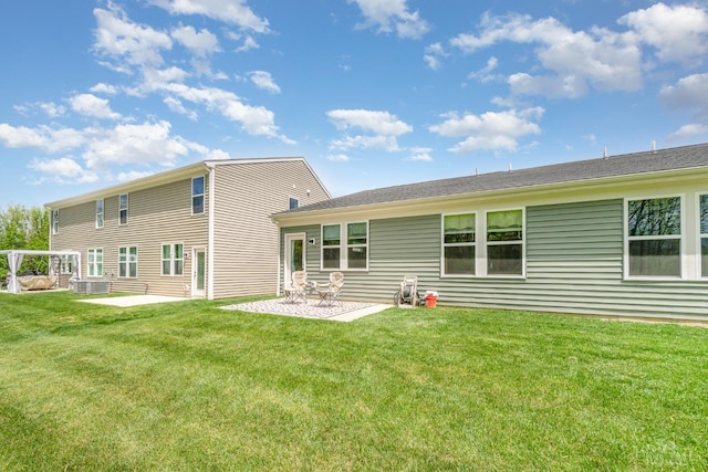 rear view of property with a yard and a patio