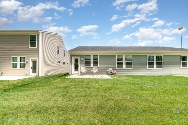rear view of house with a patio area and a lawn