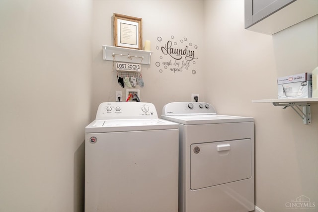 laundry area featuring washer and dryer and cabinet space