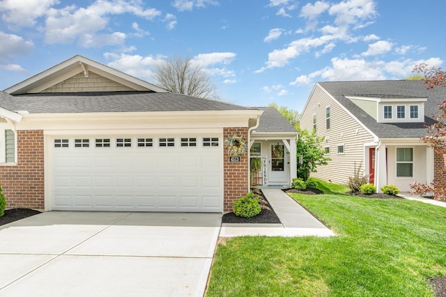 view of front of home with concrete driveway, a garage, a front lawn, and brick siding