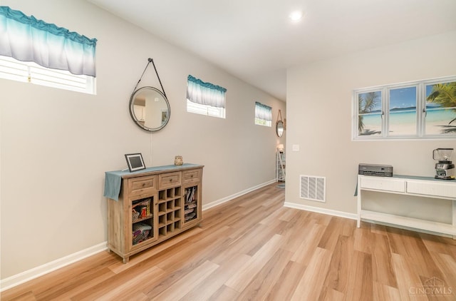 interior space featuring recessed lighting, baseboards, visible vents, and light wood-style floors