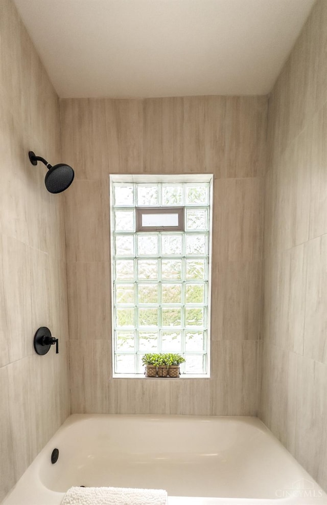 full bath featuring walk in shower and a bathing tub
