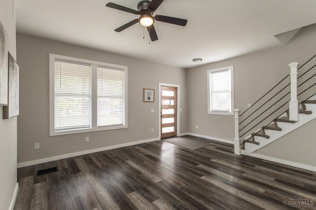 entryway with ceiling fan, dark wood finished floors, visible vents, and stairway