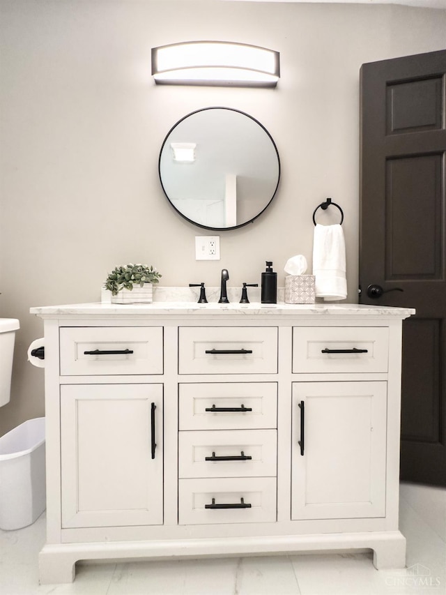 bathroom with toilet and vanity