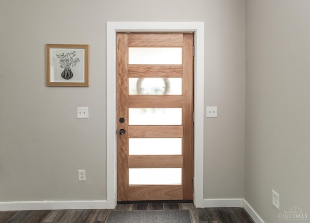 foyer featuring baseboards and dark wood finished floors