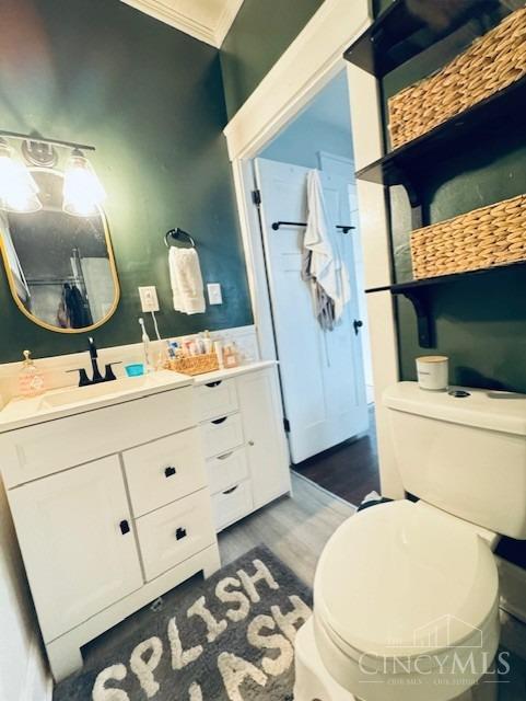2848 Markbreit Ave, Cincinnati, OH 45209 - full bathroom featuring vanity, crown molding, wood finished floors, and toilet