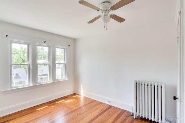 2848 Markbreit Ave, Cincinnati, OH 45209 - empty room featuring radiator heating unit, light wood-style flooring, baseboards, and a ceiling fan