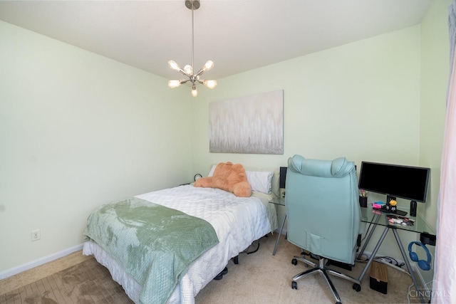 carpeted bedroom with a chandelier and baseboards